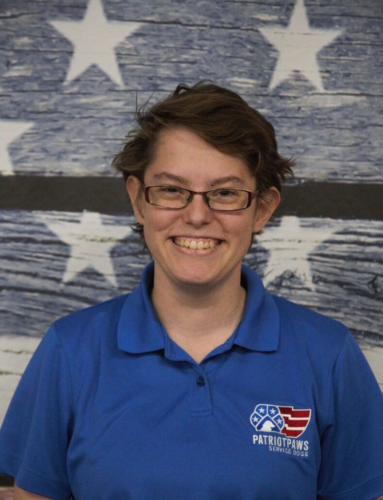 A woman in glasses and an american flag shirt.