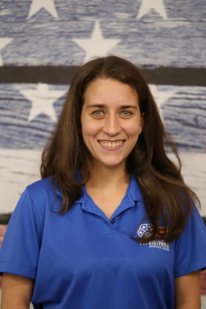 A woman in blue shirt smiling for the camera.