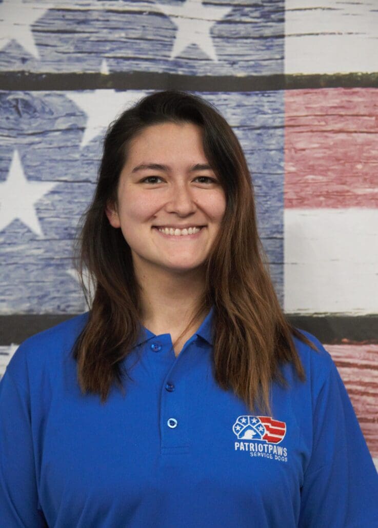 A woman standing in front of an american flag.