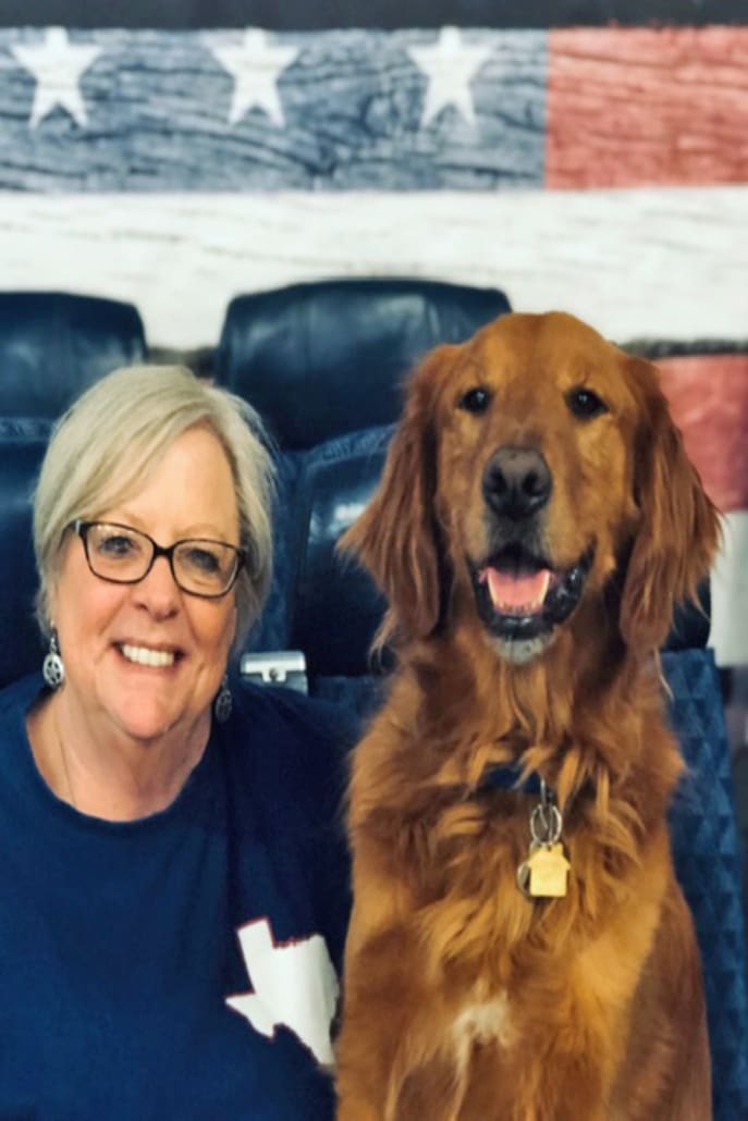 A woman and her dog are sitting in the seats.