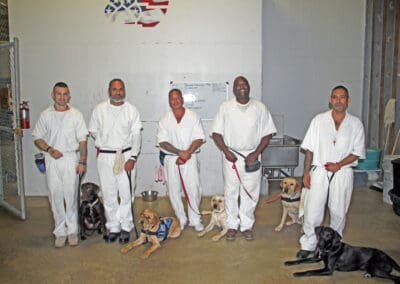 A group of men in white uniforms holding sticks.